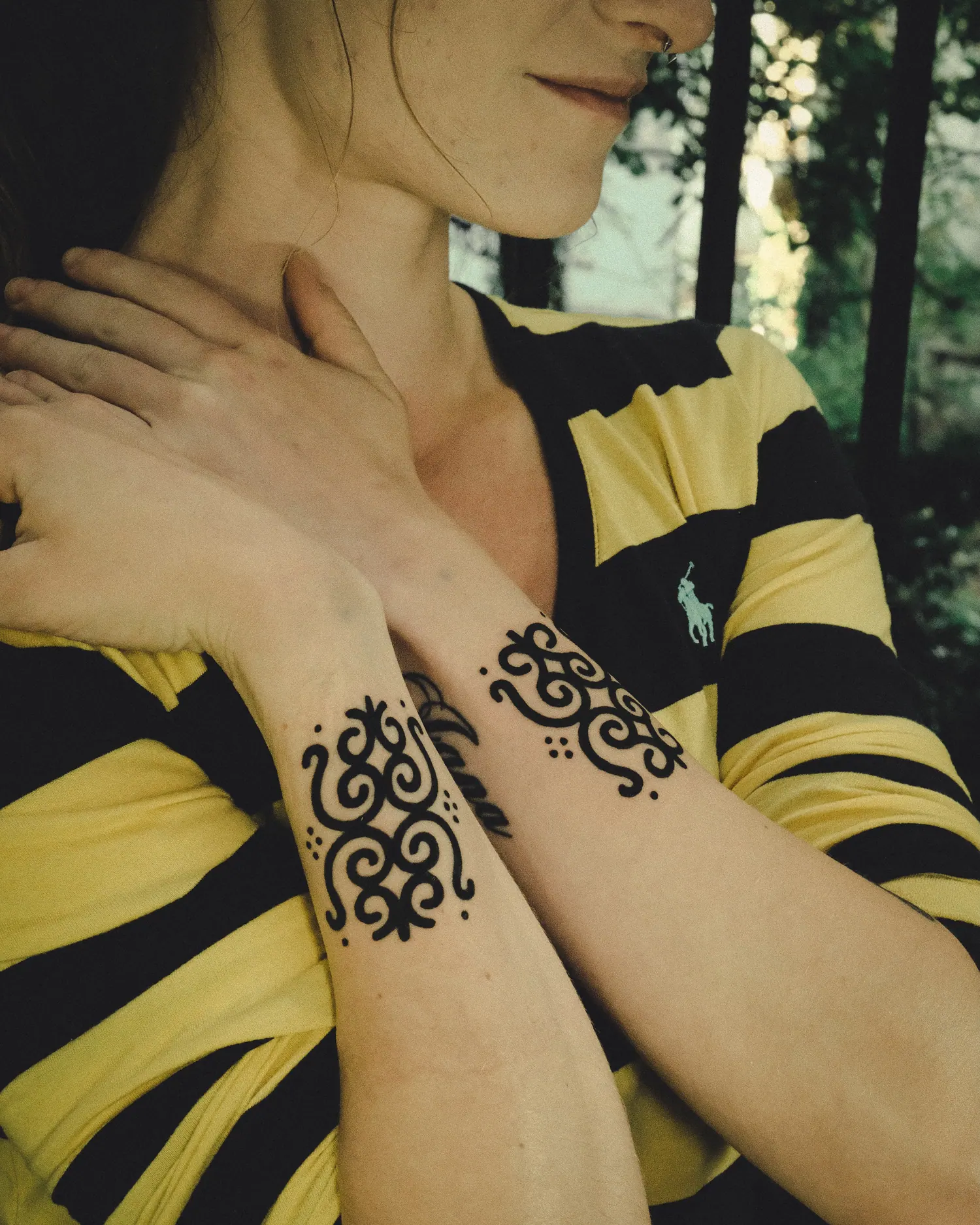 Belgrade inspired ornaments tattooed on a shoulder and a hand
