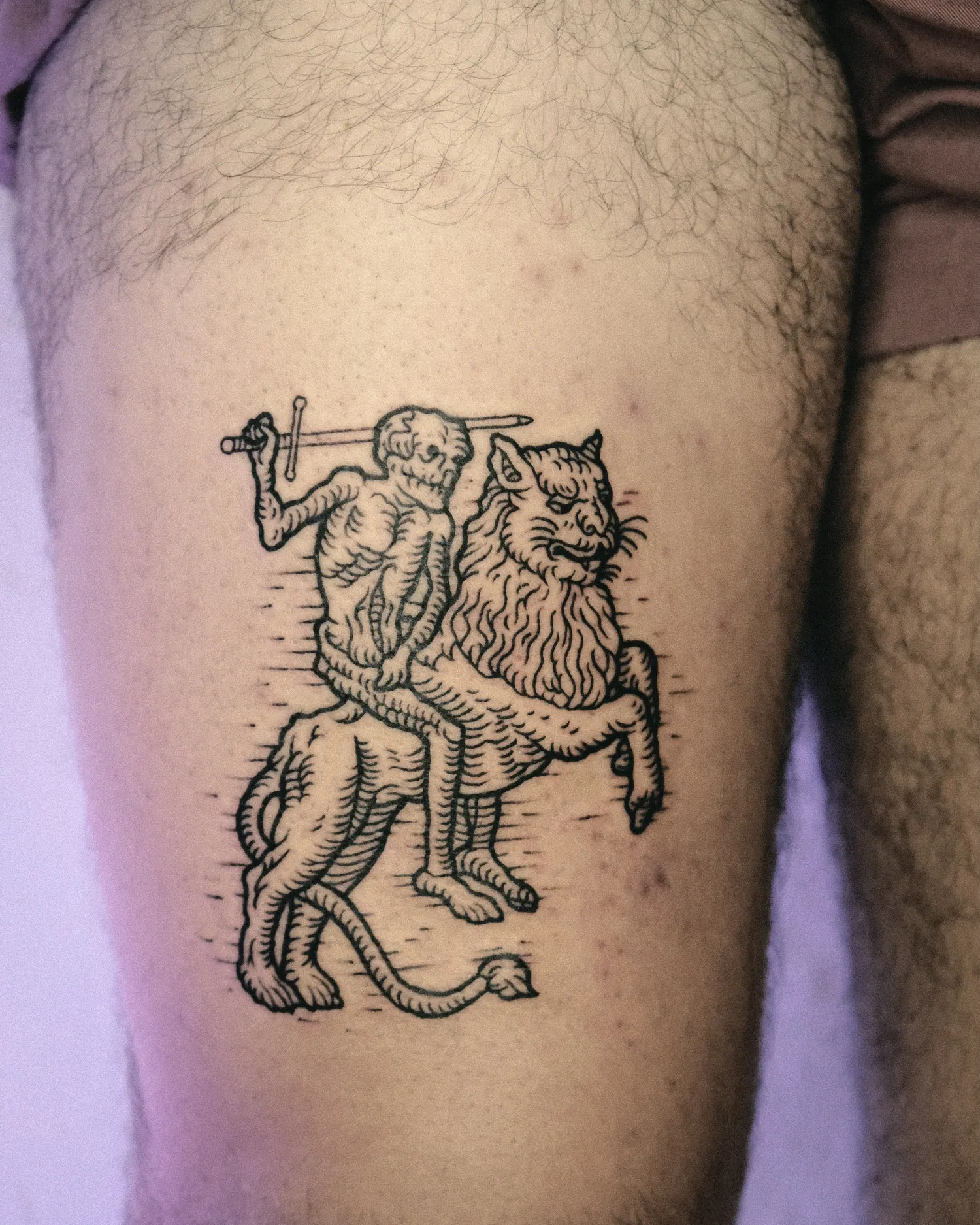 A lion rider tattooed on the thigh