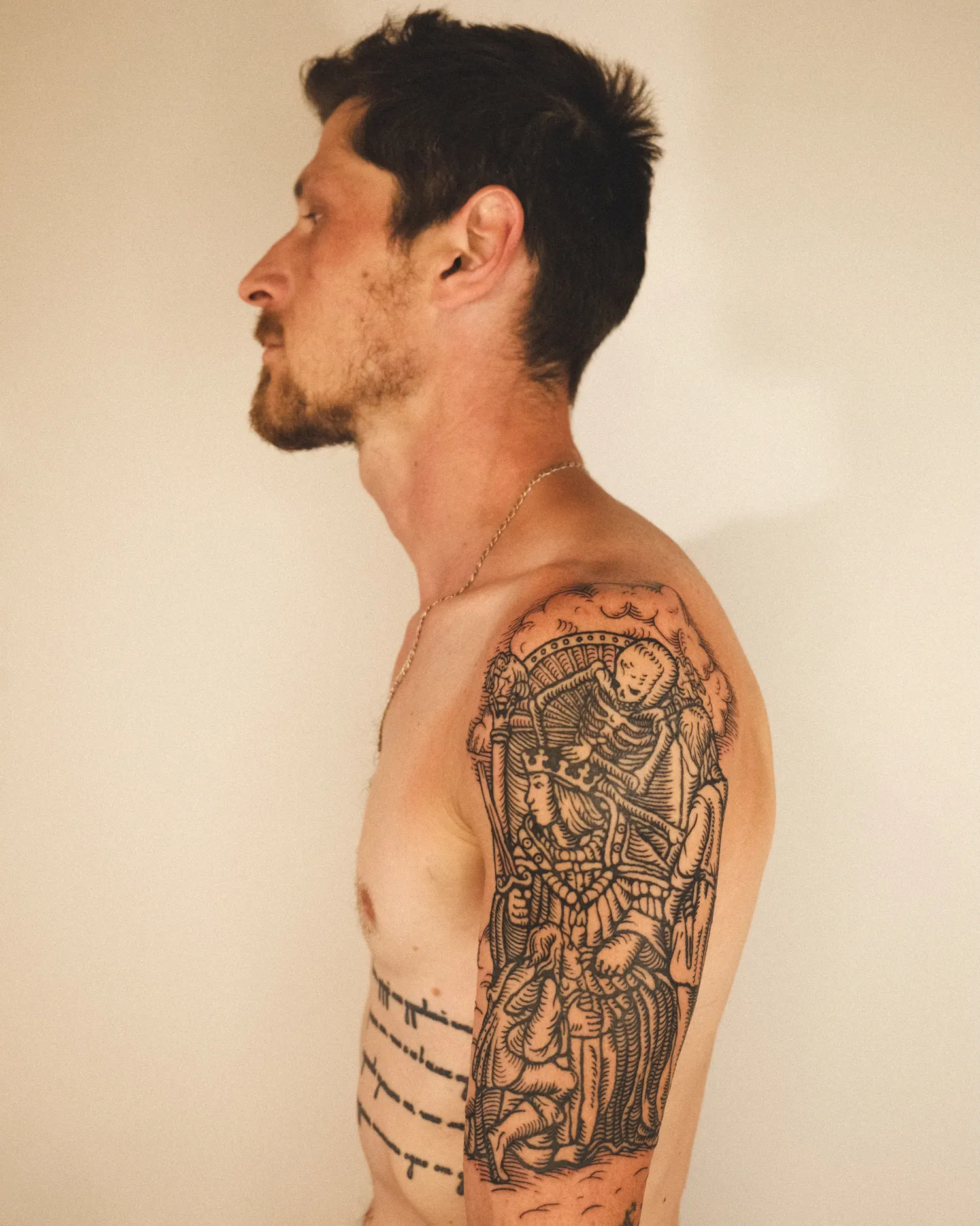 Totentanz, a large tattoo on the shoulder and upper arm